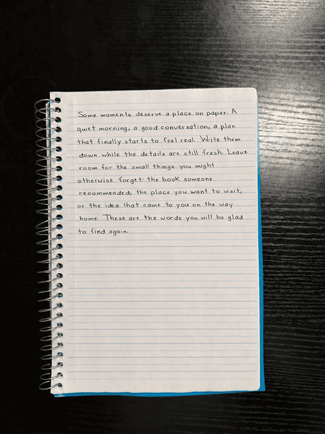 The same handwritten paragraph on a fully visible photographed notebook page